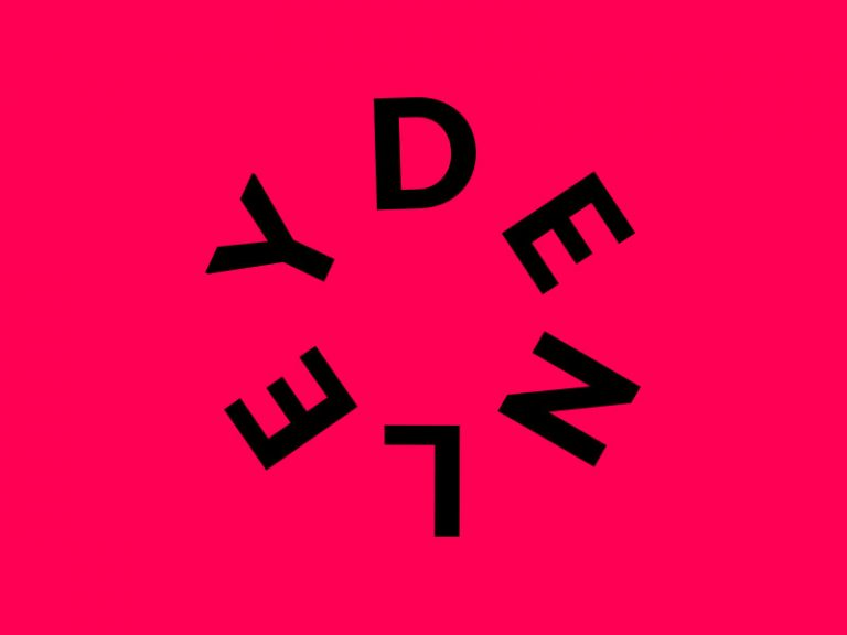 Studio Denley circular logo, black on a magenta background