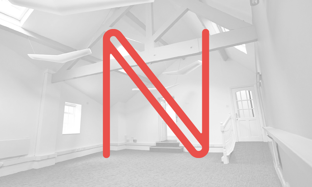 Stylised N in red on a faded black and white photograph of an office interior